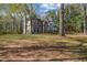 Large backyard with a mature tree canopy and verdant lawn at 3139 Players Dr, Jonesboro, GA 30236