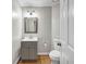 Cozy bathroom with a gray vanity, new hardware, and hardwood floors at 3139 Players Dr, Jonesboro, GA 30236