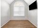 This bedroom features a vaulted window and wood floors at 3139 Players Dr, Jonesboro, GA 30236