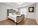 Comfortable bedroom boasts hardwood floors, natural light, and stylish decor at 3139 Players Dr, Jonesboro, GA 30236
