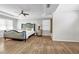 Large bedroom with a ceiling fan, lots of natural light, and sleek wood floors at 3139 Players Dr, Jonesboro, GA 30236