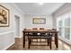 Dining room with a wooden table, bench, and chairs situated near a bright window at 3139 Players Dr, Jonesboro, GA 30236