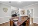 Dining room with hardwood floors that opens up to the foyer, living room, and kitchen at 3139 Players Dr, Jonesboro, GA 30236