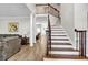 Inviting foyer with hardwood floors, staircase with wrought iron railing, and views into the living spaces at 3139 Players Dr, Jonesboro, GA 30236