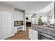 Open kitchen with granite counters, breakfast bar, and views of the living room at 3139 Players Dr, Jonesboro, GA 30236