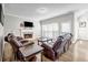 Cozy living room with a fireplace, comfortable seating, and natural light from large windows at 3139 Players Dr, Jonesboro, GA 30236