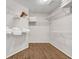 Spacious walk-in closet featuring built-in shelving and ample storage space with hardwood floors at 3139 Players Dr, Jonesboro, GA 30236