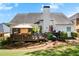 Exterior shot of the home showcasing a large backyard, a deck, and mature trees at 561 Valleyside Dr, Dallas, GA 30157