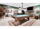 Finished basement with a pool table, stone fireplace, and a bar area, perfect for entertaining at 561 Valleyside Dr, Dallas, GA 30157