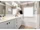 Elegant bathroom featuring a soaking tub, double vanity sinks, modern fixtures, and neutral decor at 561 Valleyside Dr, Dallas, GA 30157