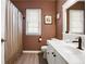 Classic bathroom with warm brown walls, white cabinetry, and a shower-tub combo for a cozy feel at 561 Valleyside Dr, Dallas, GA 30157