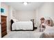 Simple bedroom featuring a white bed, matching white walls, and a dollhouse for a cozy, clean look at 561 Valleyside Dr, Dallas, GA 30157