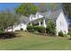 Beautiful two-story home featuring a cozy front porch, white siding and a green lawn with shrubs at 561 Valleyside Dr, Dallas, GA 30157
