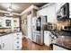 Well-equipped kitchen with stainless steel appliances, granite countertops, and white cabinets at 561 Valleyside Dr, Dallas, GA 30157
