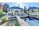 A backyard with a pool, lounge chairs, grill, outdoor dining area, and large home at 7080 Greatwood Trl, Alpharetta, GA 30005