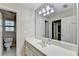 Bright bathroom featuring a wide mirror over a cultured marble vanity and a separate toilet room at 7080 Greatwood Trl, Alpharetta, GA 30005