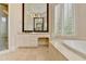 Bright bathroom featuring marble floors, a vanity, and a luxurious soaking tub and a large shower at 7080 Greatwood Trl, Alpharetta, GA 30005