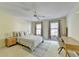 This well-lit bedroom features neutral walls, carpeted floors, and large windows for plentiful natural light at 7080 Greatwood Trl, Alpharetta, GA 30005