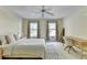 This well-lit bedroom features neutral walls, carpeted floors, and large windows for plentiful natural light at 7080 Greatwood Trl, Alpharetta, GA 30005