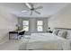 This bright bedroom is complete with a ceiling fan, large windows, and a quaint desk space at 7080 Greatwood Trl, Alpharetta, GA 30005
