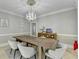 Dining room with rustic table and decorative chandelier at 7080 Greatwood Trl, Alpharetta, GA 30005