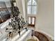Elegant foyer with curved staircase, dark wood railings, wrought iron spindles, and a large decorative chandelier at 7080 Greatwood Trl, Alpharetta, GA 30005