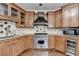 This kitchen boasts a Wolf range, granite countertops and custom wood cabinets at 7080 Greatwood Trl, Alpharetta, GA 30005