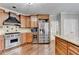 Gourmet kitchen with a Wolf range, stainless refrigerator, and custom cabinetry at 7080 Greatwood Trl, Alpharetta, GA 30005