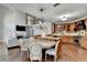 Kitchen with an island, breakfast bar, stainless steel appliances, and open views into the living room at 7080 Greatwood Trl, Alpharetta, GA 30005