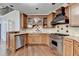 Gourmet kitchen features stainless steel appliances, granite countertops, and custom cabinetry at 7080 Greatwood Trl, Alpharetta, GA 30005