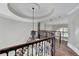Second floor landing with a wrought iron banister and view of living area at 7080 Greatwood Trl, Alpharetta, GA 30005