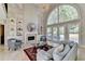 Inviting living room with large window, fireplace, neutral decor, and elegant furnishings at 7080 Greatwood Trl, Alpharetta, GA 30005