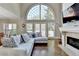 Bright living room with a fireplace and soaring windows at 7080 Greatwood Trl, Alpharetta, GA 30005