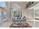 Bright living room with columns, a large window, and a view of the dining room with chandelier at 7080 Greatwood Trl, Alpharetta, GA 30005