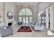 Bright living room with high ceilings, fireplace, built-in bookshelves, and expansive windows at 7080 Greatwood Trl, Alpharetta, GA 30005