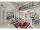 Spacious living room featuring soaring ceilings, columns, a fireplace, and a view of the dining room at 7080 Greatwood Trl, Alpharetta, GA 30005
