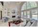 Comfortable living room featuring a fireplace, built-in shelves, and large windows offering ample light at 7080 Greatwood Trl, Alpharetta, GA 30005
