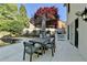 Outdoor patio seating area with an umbrella, table, and outdoor grill at 7080 Greatwood Trl, Alpharetta, GA 30005