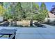 Backyard pool featuring a stone waterfall, mature landscaping, and a spacious patio at 7080 Greatwood Trl, Alpharetta, GA 30005