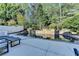Backyard pool featuring a stone waterfall, mature landscaping, and a spacious patio at 7080 Greatwood Trl, Alpharetta, GA 30005