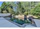 Backyard pool featuring a stone waterfall, mature landscaping, and a spacious patio at 7080 Greatwood Trl, Alpharetta, GA 30005