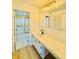 Bright bathroom featuring a large mirror, modern vanity, and a shower/tub combo with gold trim at 102 Adrian Nw Pl, Atlanta, GA 30327