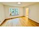 Bright bedroom features wood-look floors and a window with a view of the yard at 102 Adrian Nw Pl, Atlanta, GA 30327