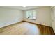 Spacious bedroom with wood-look floors, a window, and a closet at 102 Adrian Nw Pl, Atlanta, GA 30327
