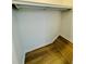 Walk-in closet featuring a hanging rod and wood-look floor at 102 Adrian Nw Pl, Atlanta, GA 30327