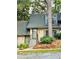 Charming townhome featuring a well-manicured front yard and traditional architectural details at 102 Adrian Nw Pl, Atlanta, GA 30327