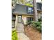 Charming townhome featuring a well-manicured front yard and traditional architectural details at 102 Adrian Nw Pl, Atlanta, GA 30327