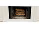 Close up of logs in the marble fireplace with mantle, ready for a cozy fire at 102 Adrian Nw Pl, Atlanta, GA 30327