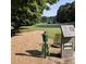 Well manicured golf course with a tee box, signage, and a green waste disposal can at 102 Adrian Nw Pl, Atlanta, GA 30327