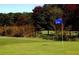 A well-manicured green and blue flag on the Cross Creek Golf Course at 102 Adrian Nw Pl, Atlanta, GA 30327